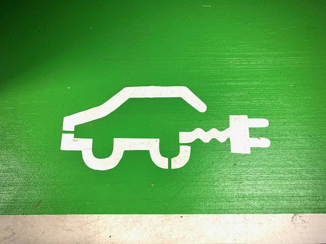 Green Parking Space With White Electric Vehicle Symbol